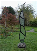 Vertical etched glass sculpture titled 