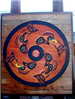 Wooden painted wall art of fish in a Native American spirit wheel titled 