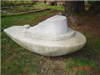 Medium-size stone sculpture of a tugboat titled 