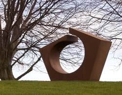 Standing stone sculpture with large hole in center titled 
